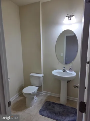 a bathroom with a sink toilet and a mirror