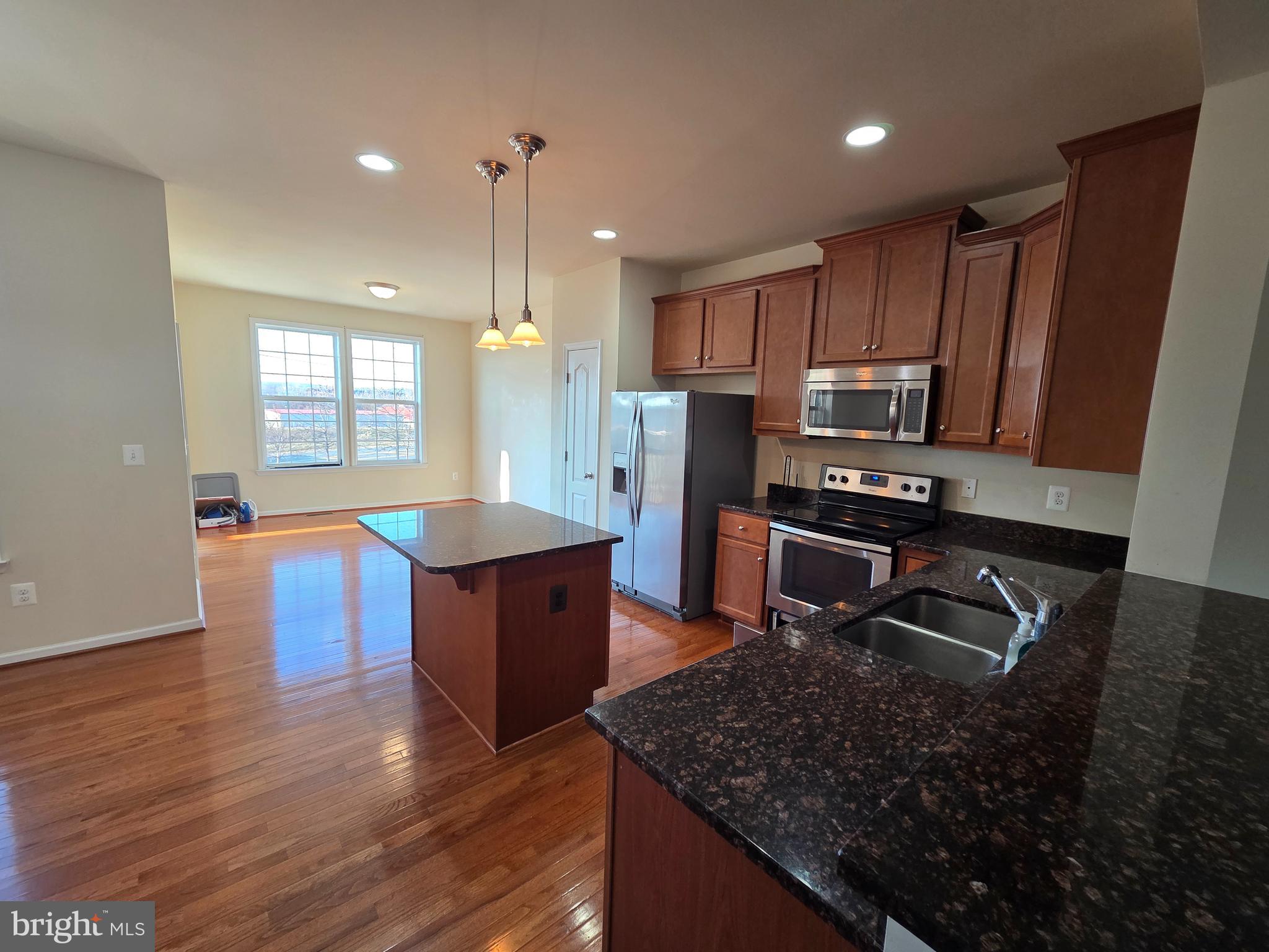 129 Schramm Loop Stephens City, VA 22655 - Photo 4 of 20 a kitchen with stainless steel appliances granite countertop a sink stove and refrigerator