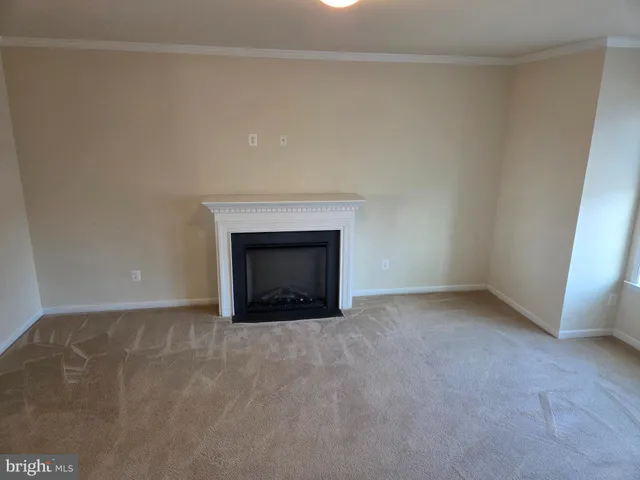 a view of empty room with a fireplace