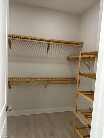 a view of wooden floor and windows in a room