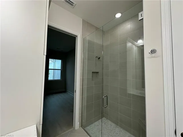 a bathroom with a shower and a sink
