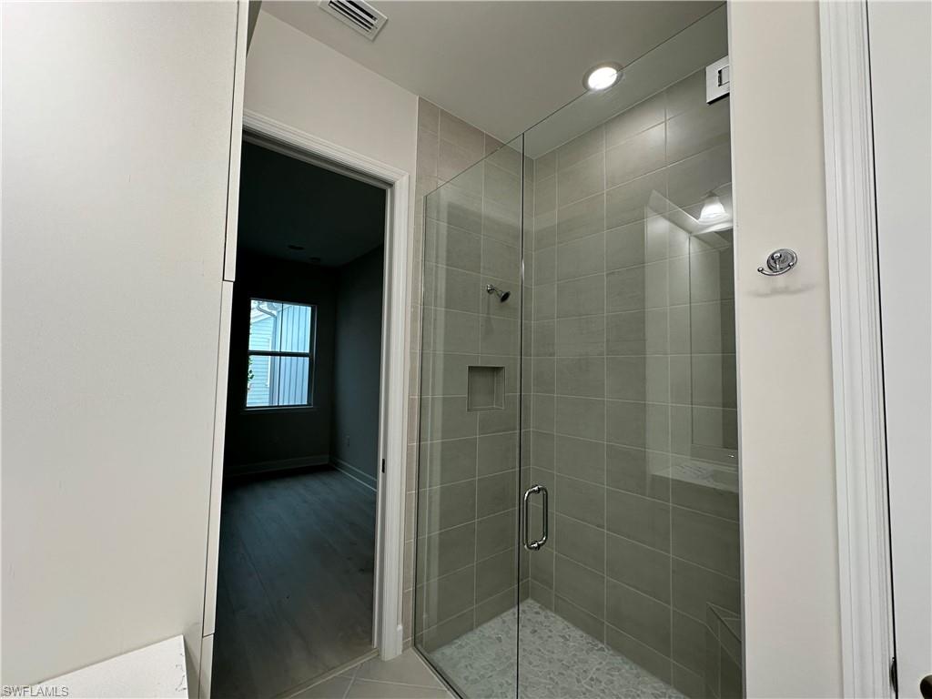 7255 Saona Court Naples, FL 34113 - Photo 13 of 28 a bathroom with a shower and a sink