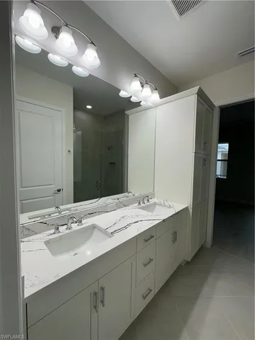 a bathroom with a sink double vanity and a mirror