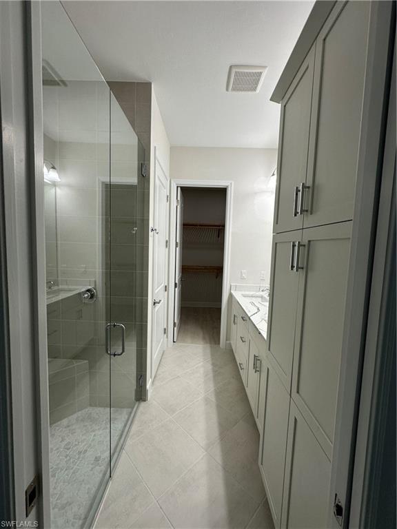 7255 Saona Court Naples, FL 34113 - Photo 15 of 28 a bathroom with a shower and a sink