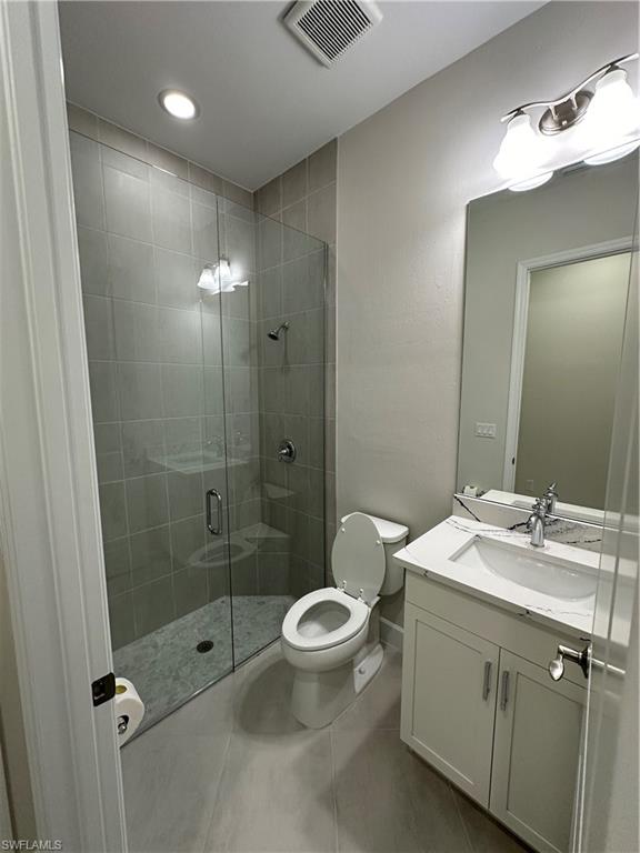 7255 Saona Court Naples, FL 34113 - Photo 18 of 28 a bathroom with a sink a toilet and shower