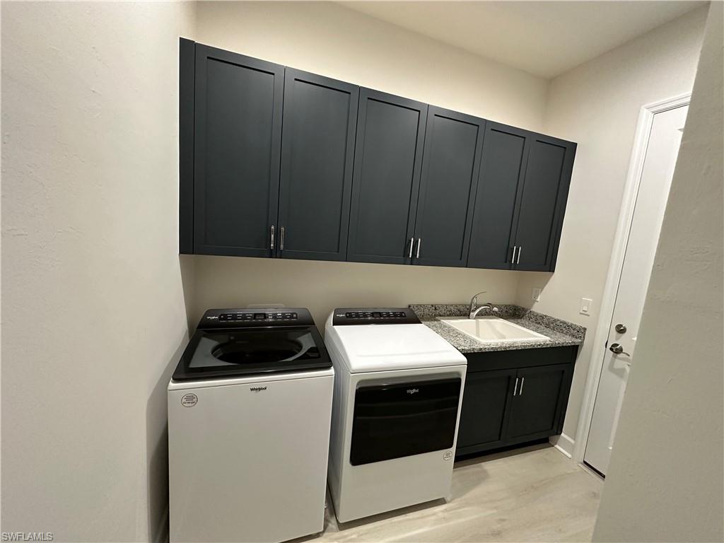 7255 Saona Court Naples, FL 34113 - Photo 19 of 28 a kitchen with a cabinets and a stove top oven