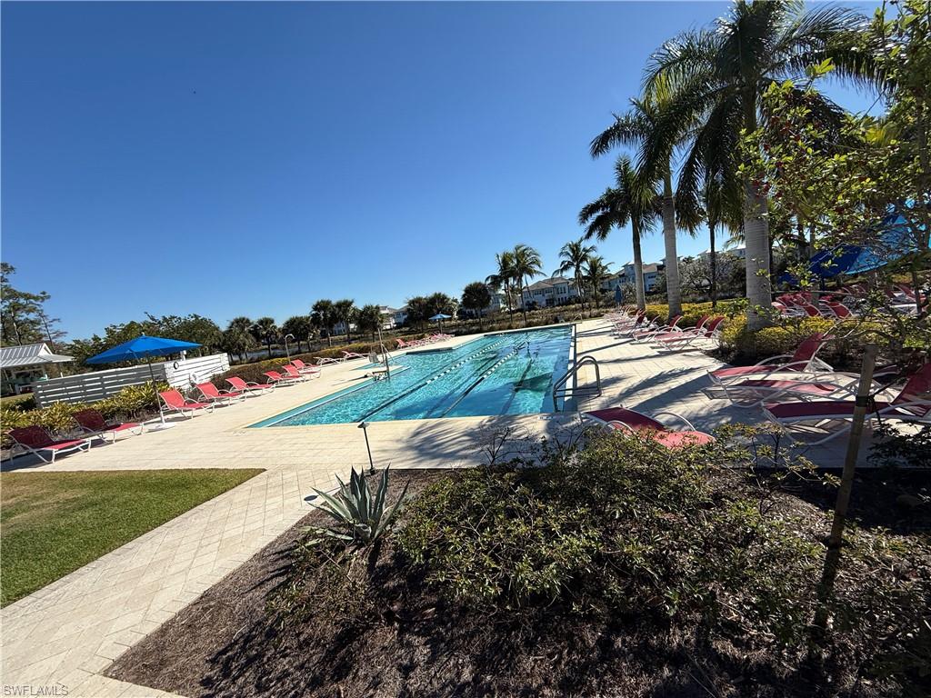 7255 Saona Court Naples, FL 34113 - Photo 27 of 28 a view of a yard with palm trees