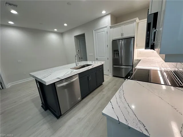 a kitchen with a sink and a refrigerator