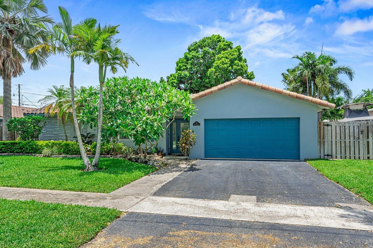 105 Orchard Ridge Lane Boca Raton, FL 33431 - Photo 29 of 37 a front view of a house with a yard and garage