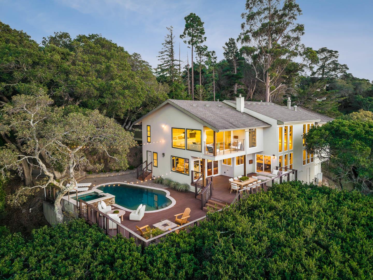 an aerial view of a house with swimming pool garden and patio