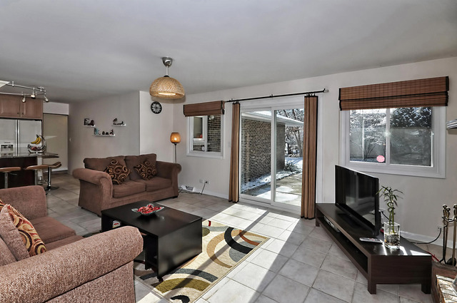 605 West Gilbert Road Palatine, IL 60067 - Photo 11 of 25 a living room with furniture a flat screen tv and a fireplace