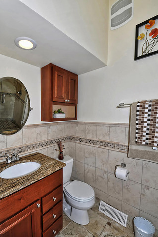 605 West Gilbert Road Palatine, IL 60067 - Photo 17 of 25 a bathroom with a granite countertop toilet sink and mirror