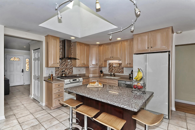 605 West Gilbert Road Palatine, IL 60067 - Photo 8 of 25 a kitchen with refrigerator a stove and chairs