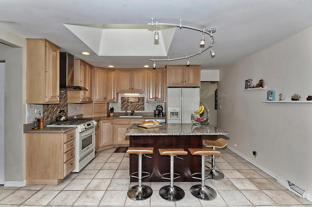 605 West Gilbert Road Palatine, IL 60067 - Photo 9 of 25 a kitchen with kitchen island granite countertop a sink appliances cabinets and furniture