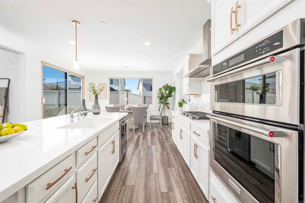33288 Skyview Road Winchester, CA 92596 - Photo 13 of 51 a large white kitchen with sink and stove