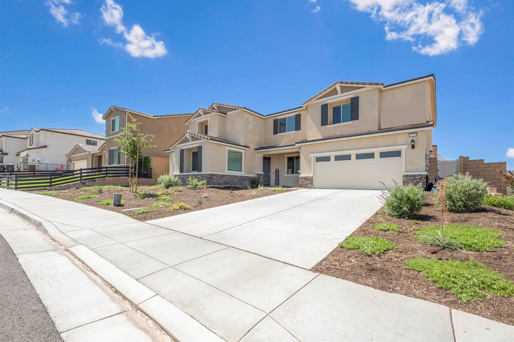 33288 Skyview Road Winchester, CA 92596 - Photo 2 of 51 a front view of a building with a garden and plants