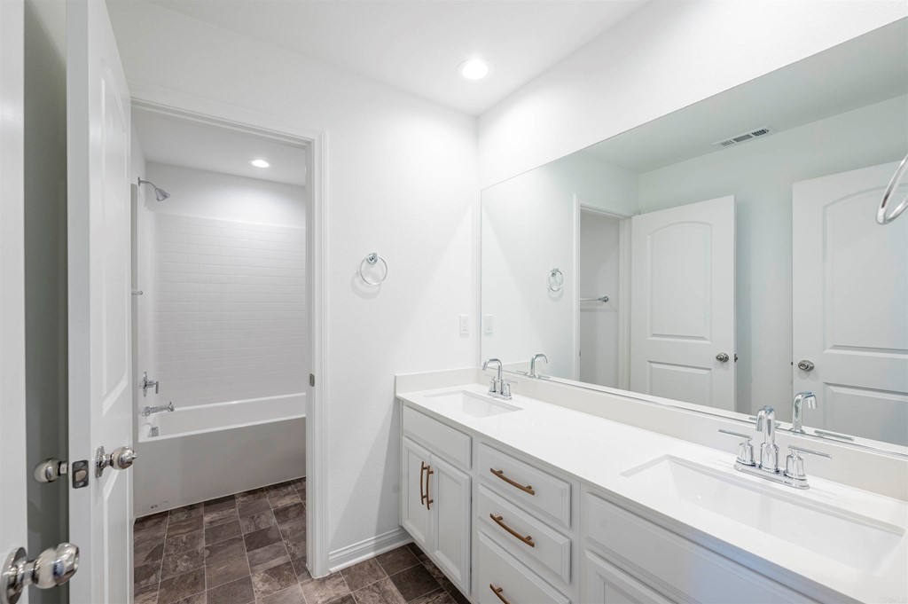33288 Skyview Road Winchester, CA 92596 - Photo 44 of 51 a bathroom with a double vanity sink large mirror and a bathtub