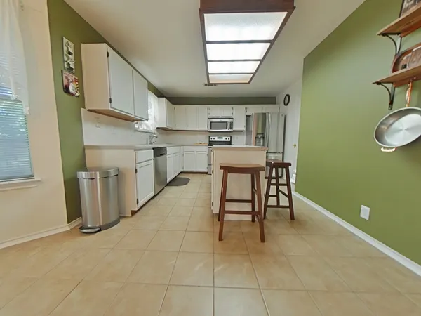a dining room with furniture and a window