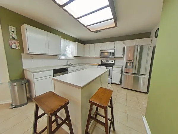 a kitchen with stainless steel appliances a refrigerator sink and stove