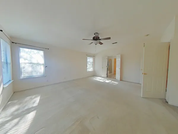 an empty room with windows and closet
