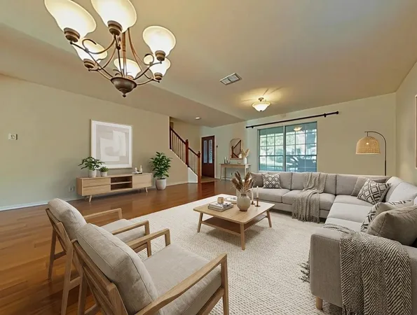 a living room with furniture chandelier and a window