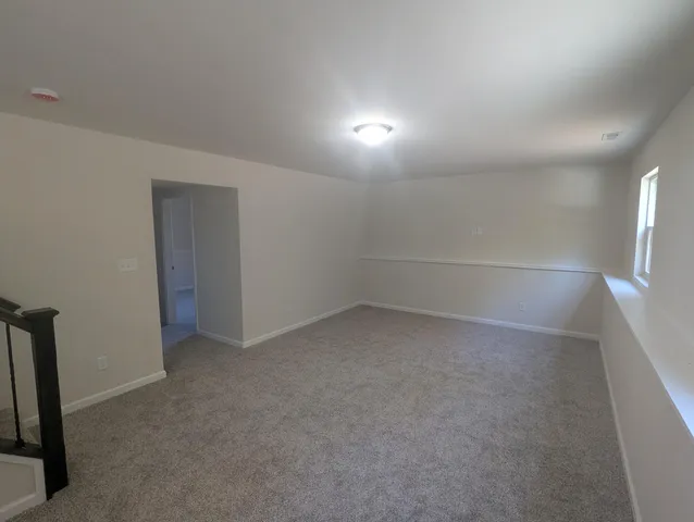 a view of an empty room with stairs