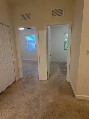 an empty room with windows and entrance