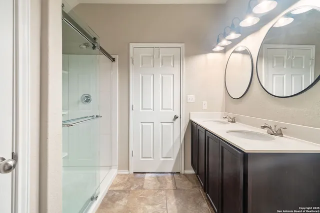 a bathroom with a mirror sink and vanity