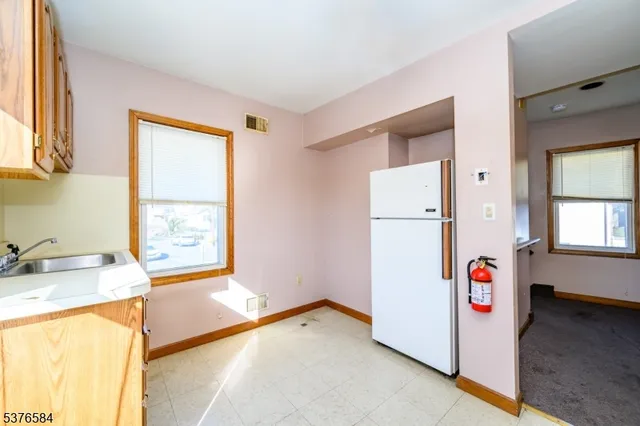 a kitchen with granite countertop white cabinets and white appliances