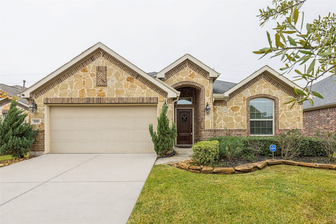 3876 Oakmist Bend Lane Spring, TX 77386 - Photo 1 of 41 a front view of a house with a yard and garage