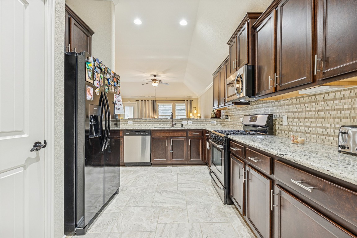 3876 Oakmist Bend Lane Spring, TX 77386 - Photo 13 of 41 a large kitchen with stainless steel appliances granite countertop a stove and a refrigerator