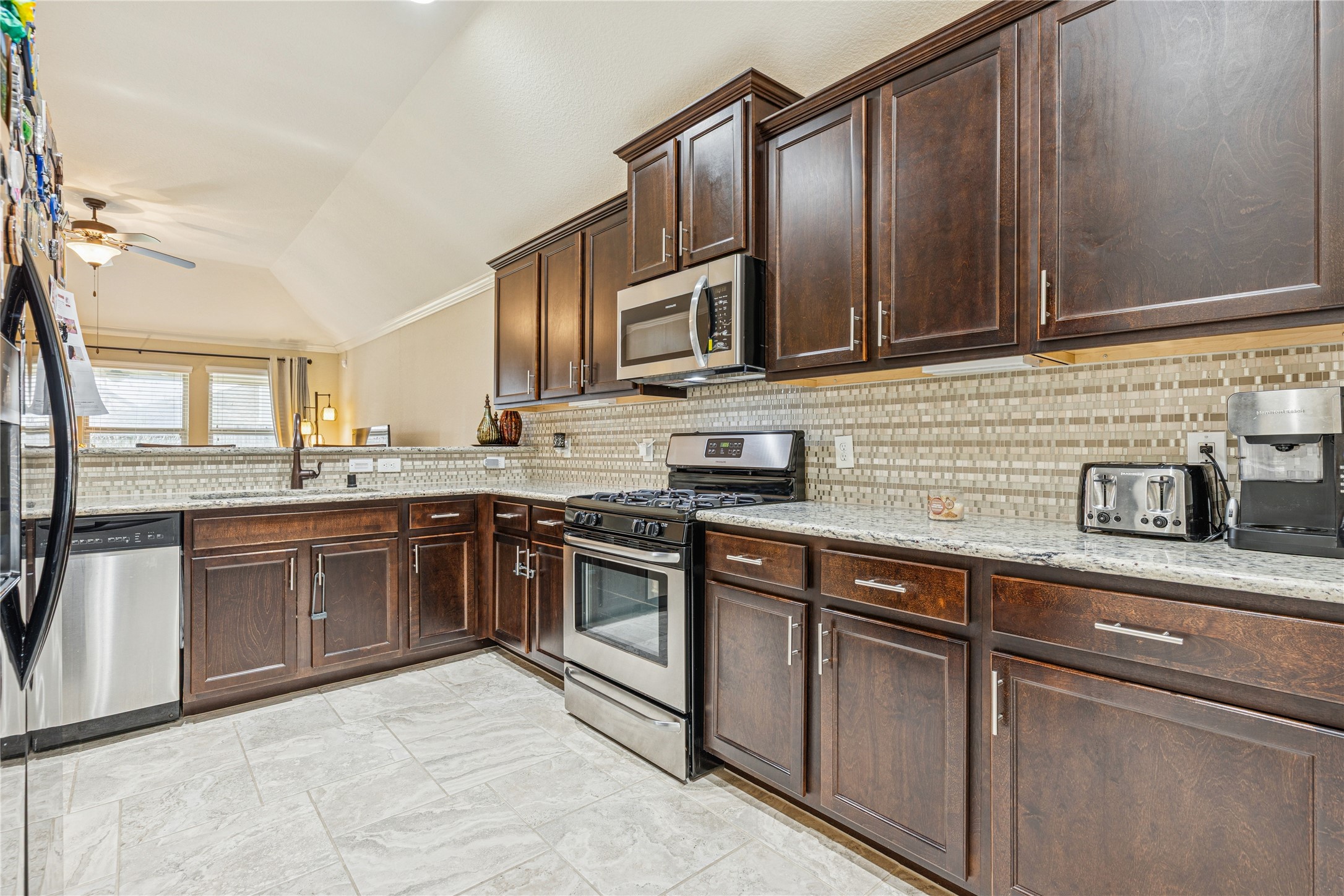 3876 Oakmist Bend Lane Spring, TX 77386 - Photo 14 of 41 a kitchen with stainless steel appliances granite countertop a sink stove and microwave