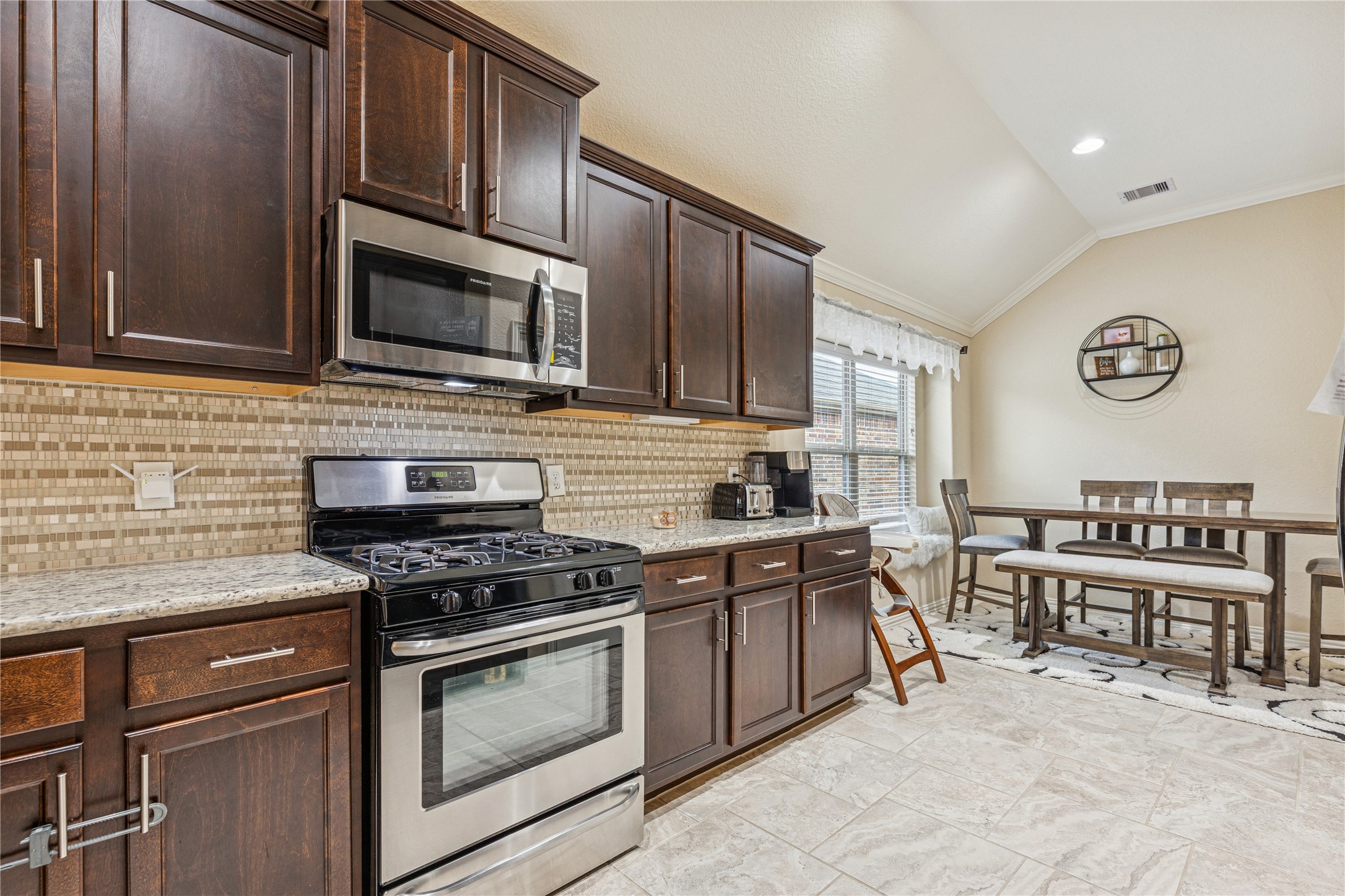3876 Oakmist Bend Lane Spring, TX 77386 - Photo 15 of 41 a kitchen with stainless steel appliances a stove sink microwave and cabinets