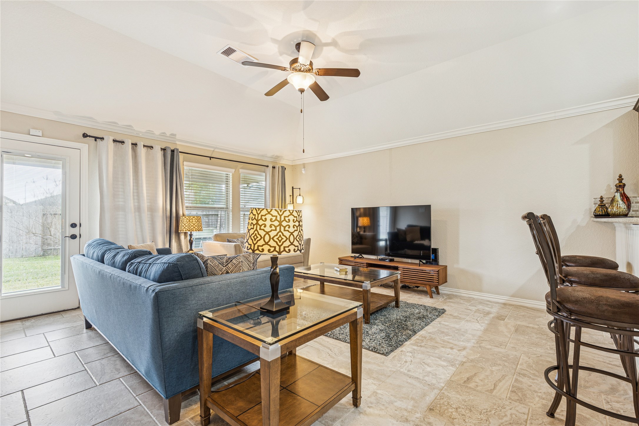 3876 Oakmist Bend Lane Spring, TX 77386 - Photo 17 of 41 a living room with furniture and a flat screen tv