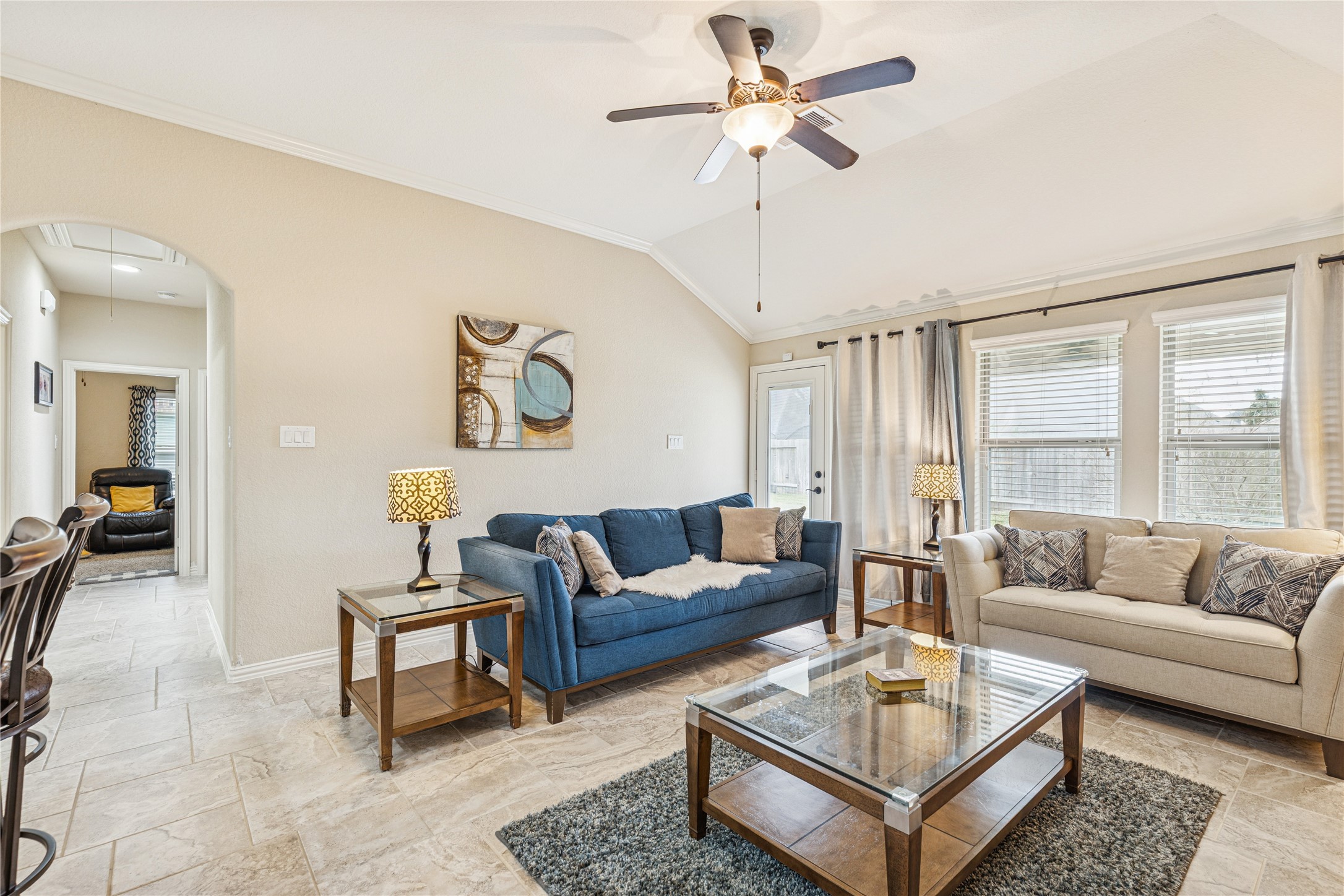 3876 Oakmist Bend Lane Spring, TX 77386 - Photo 20 of 41 a living room with furniture a rug and a chandelier