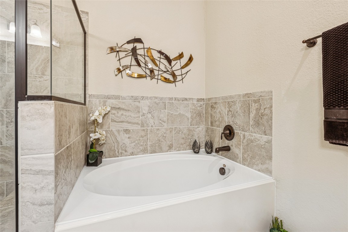 3876 Oakmist Bend Lane Spring, TX 77386 - Photo 30 of 41 a bathroom with a bathtub and a shower