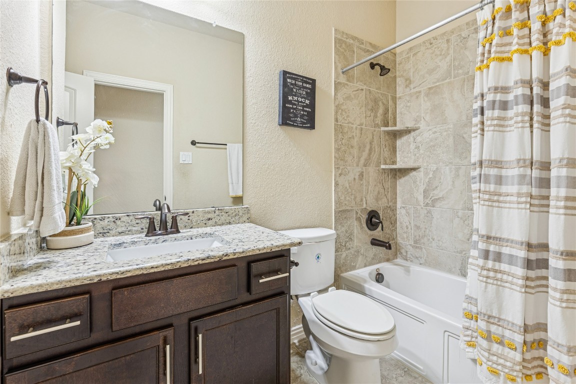 3876 Oakmist Bend Lane Spring, TX 77386 - Photo 33 of 41 a bathroom with a granite countertop sink toilet and shower