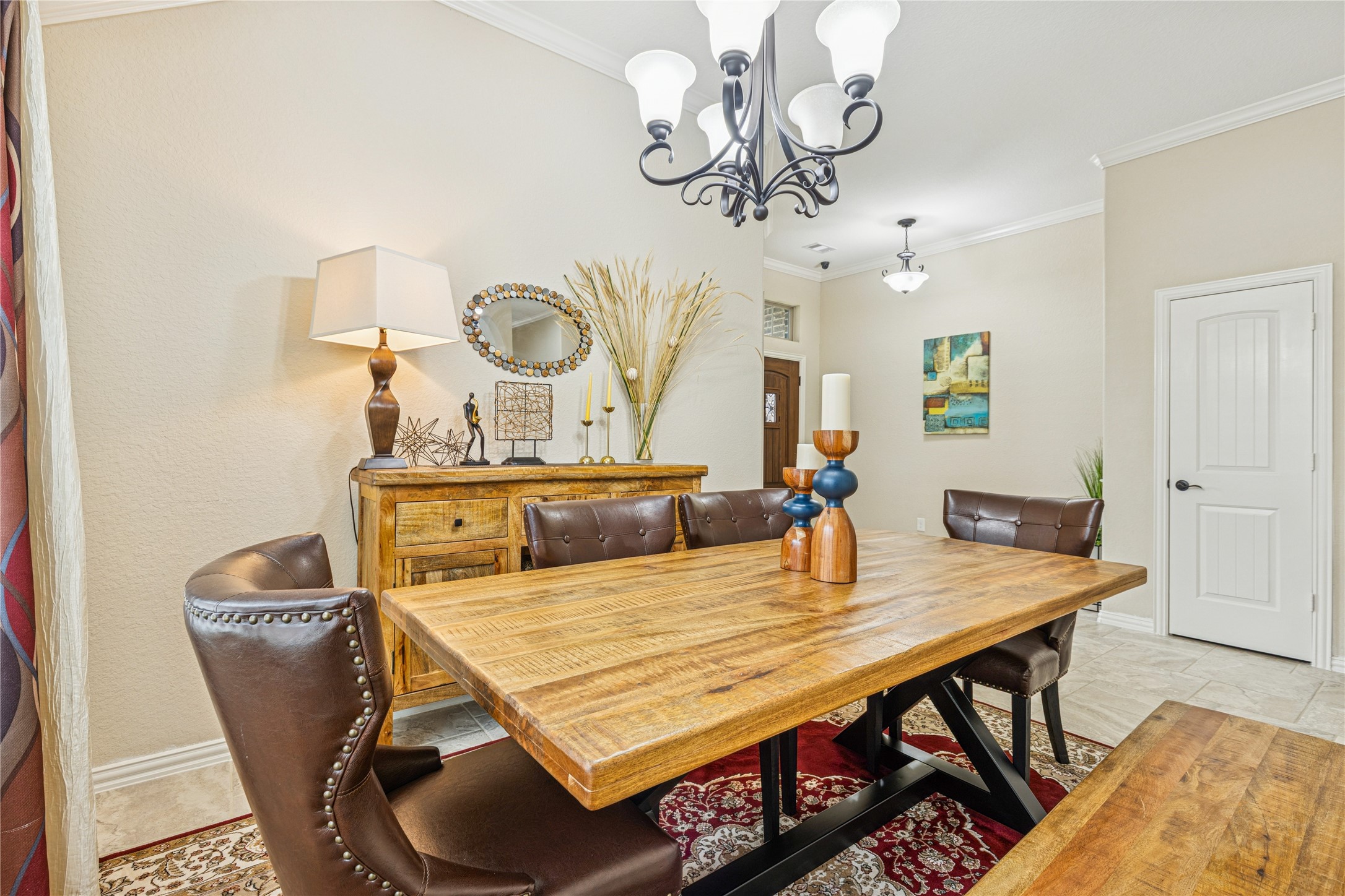 3876 Oakmist Bend Lane Spring, TX 77386 - Photo 5 of 41 a dining room with wooden floor a chandelier a wooden table and chairs