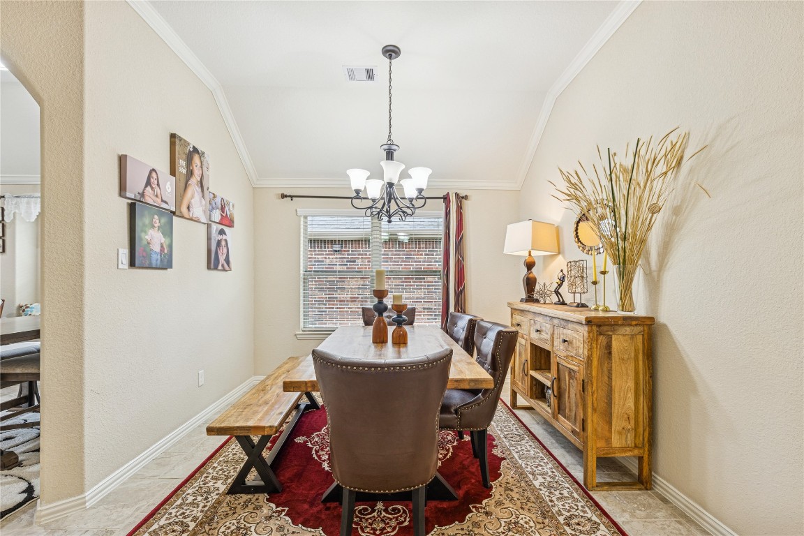 3876 Oakmist Bend Lane Spring, TX 77386 - Photo 6 of 41 a dining room with furniture a rug and a chandelier