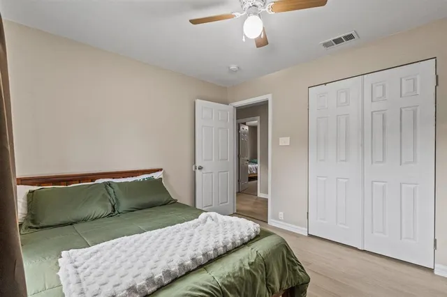 a bedroom with a bed and cabinets