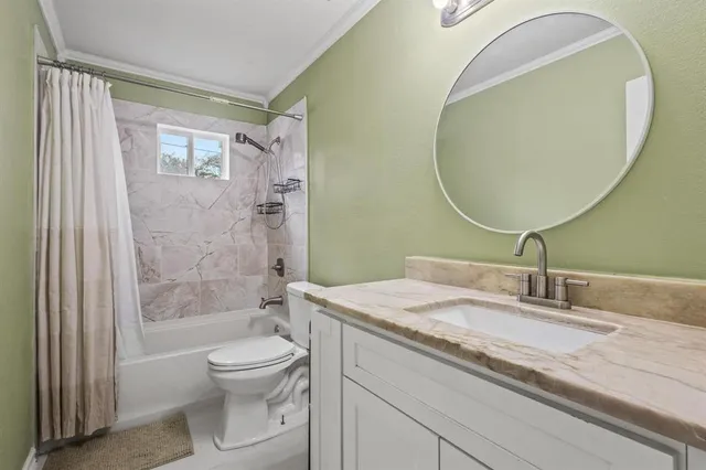 a bathroom with a granite countertop toilet a sink and a mirror