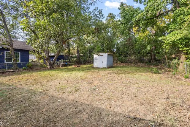 a backyard of a house with yard and outdoor seating