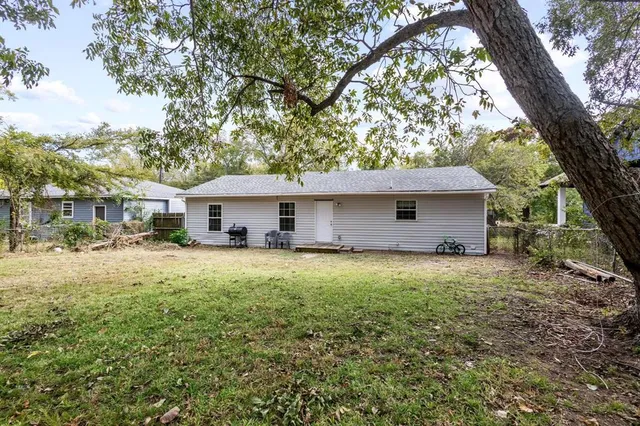 a front view of house with yard and trees
