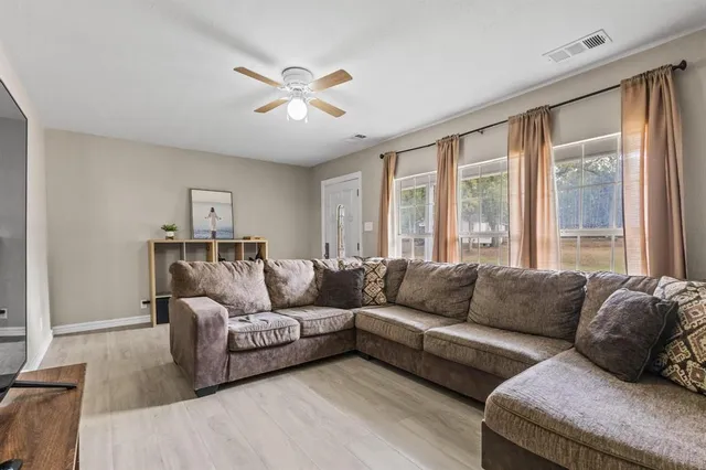 a living room with furniture and a large window