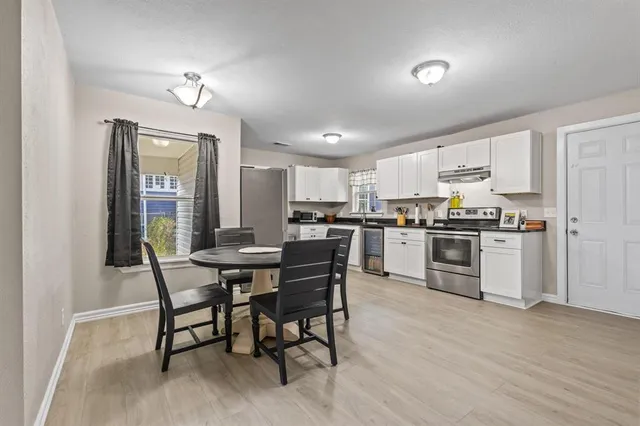 a view of kitchen with cabinets table and chairs