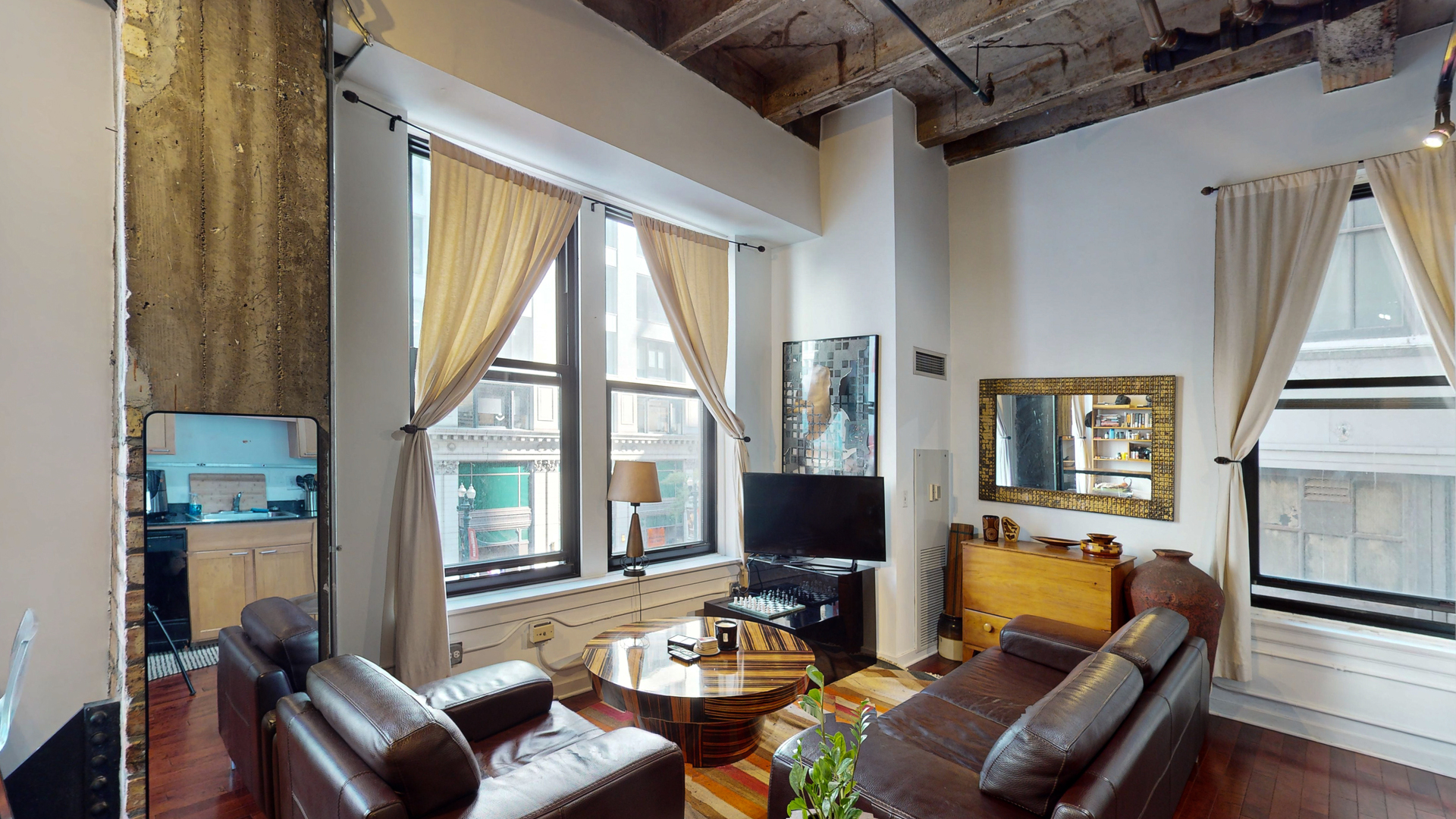 20 North State Street, Unit 307 Chicago, IL 60602 - Photo 3 of 7 a living room with furniture a flat screen tv and a large window
