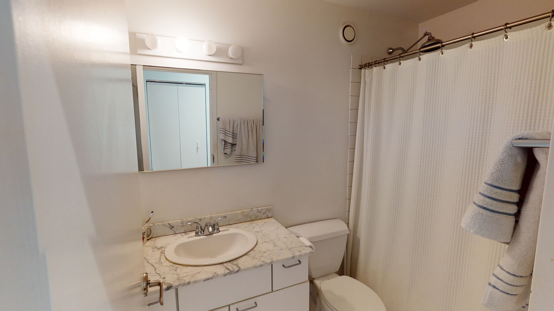 20 North State Street, Unit 307 Chicago, IL 60602 - Photo 7 of 7 a bathroom with a sink toilet and mirror