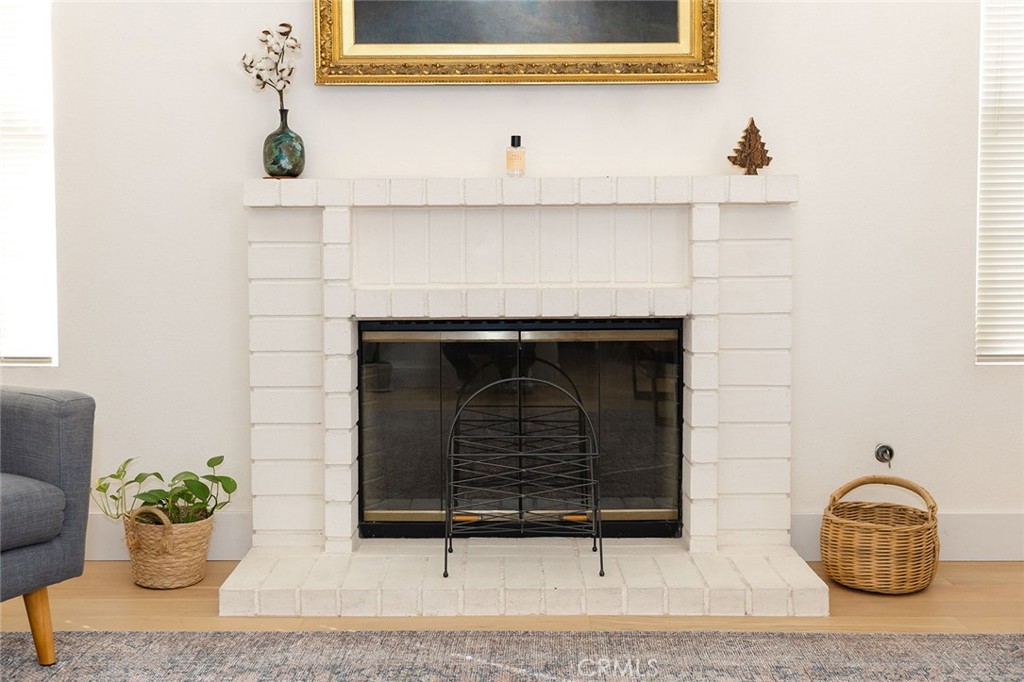 6059 Merion Court Banning, CA 92220 - Photo 14 of 48 a living room with a fireplace and a potted plant