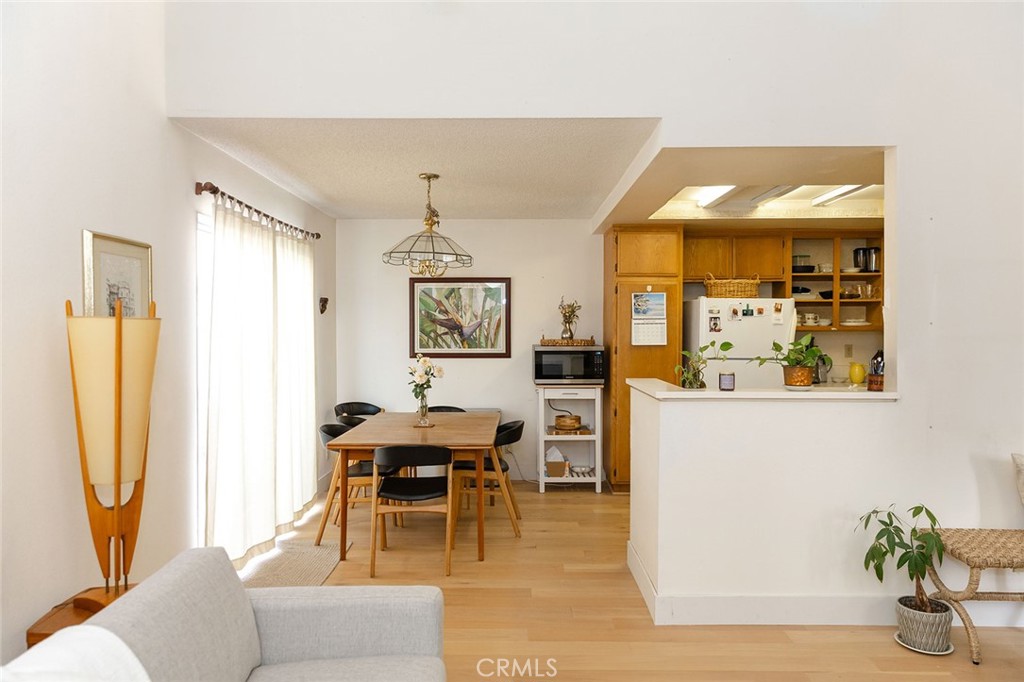 6059 Merion Court Banning, CA 92220 - Photo 16 of 48 a living room with furniture a chandelier and a dining table