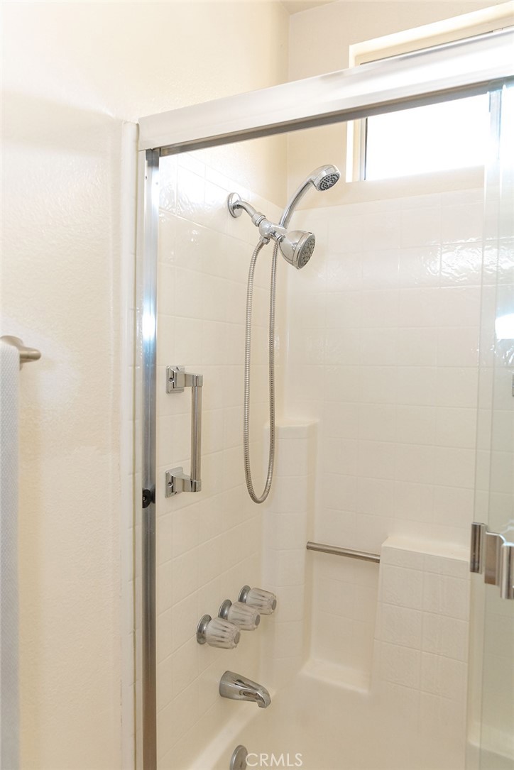 6059 Merion Court Banning, CA 92220 - Photo 31 of 48 a bathroom with a glass shower door